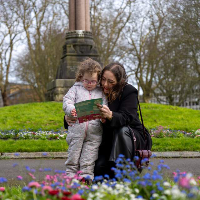 Mother and daughter looking at Easter Trail map in park