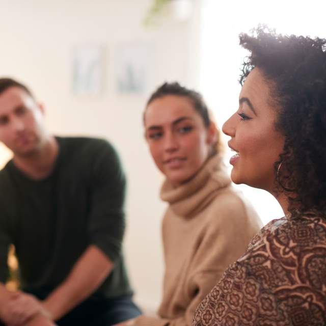 Woman talks to a group of people