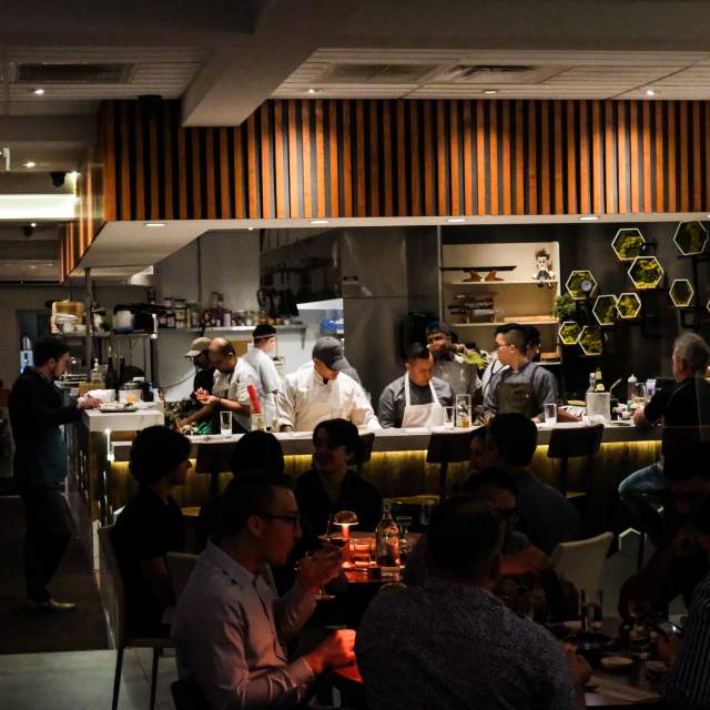interior dining area with guests at Kabooki Sushi
