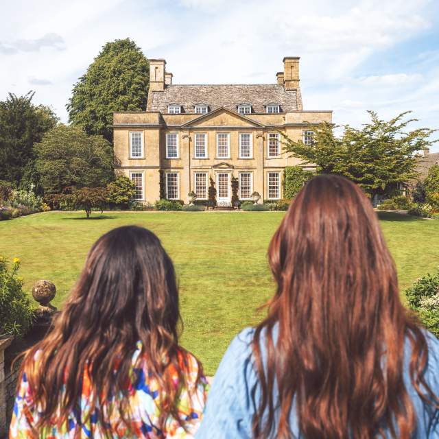 Two women looking across the lawn towards Bourton House