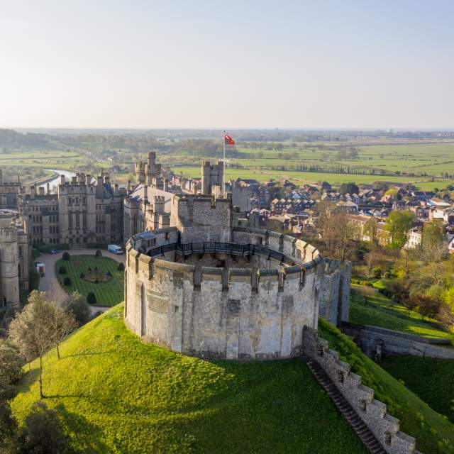 Aerial view of the keep at Arundel Castle with Arundel and fields in the distance