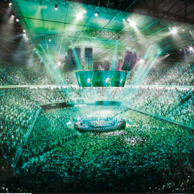 Lights shining on stage with a full crowd at AO Arena