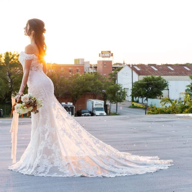 Bride standing atop the Mill at East Mckinney looking toward downtown McKinney