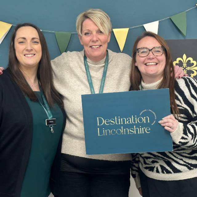 a photo of members of the Destination Lincolnshire team in front of a branded backdrop