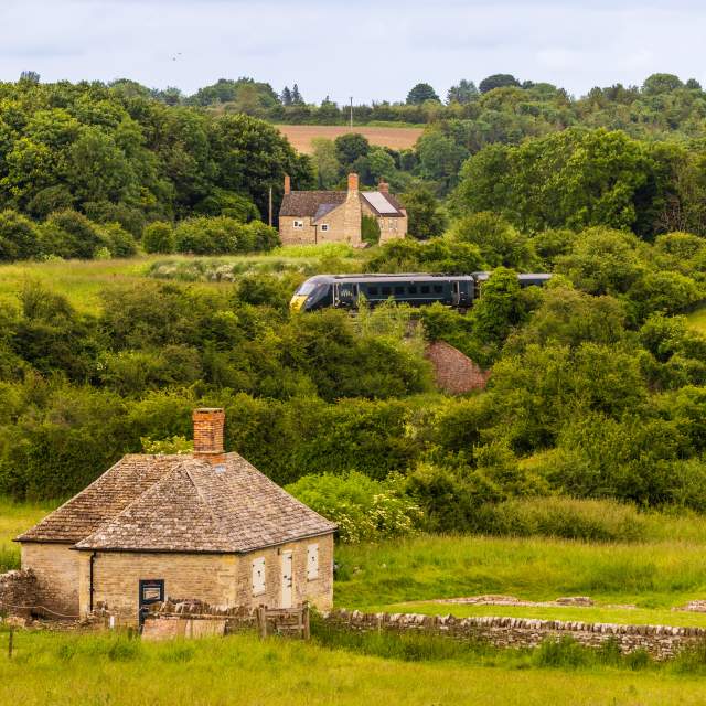 A view of North Leigh Roman Villa with a GWR train passing in the distance behind