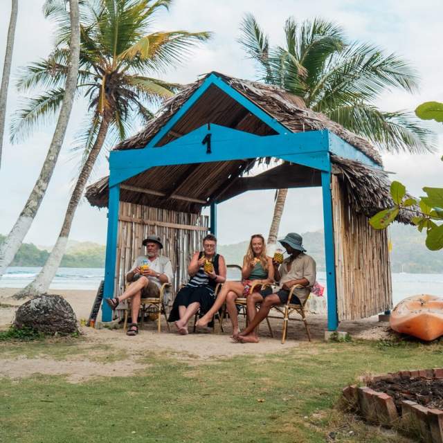Several individuals, completely at ease, enjoying each other's company in the cozy wooden house.
