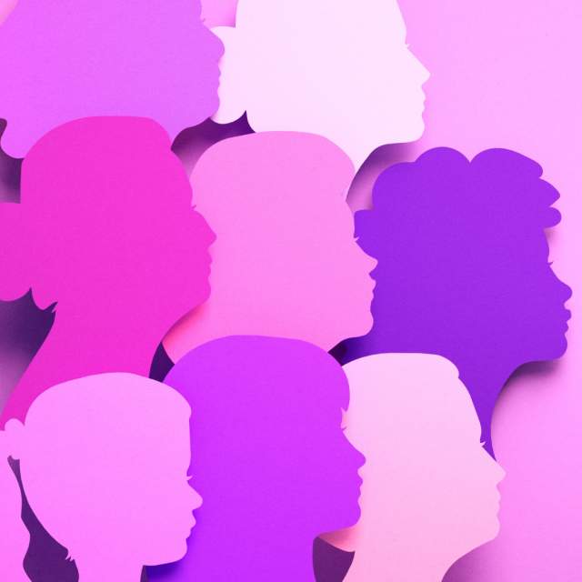 Silhouettes of women's faces on a purple background