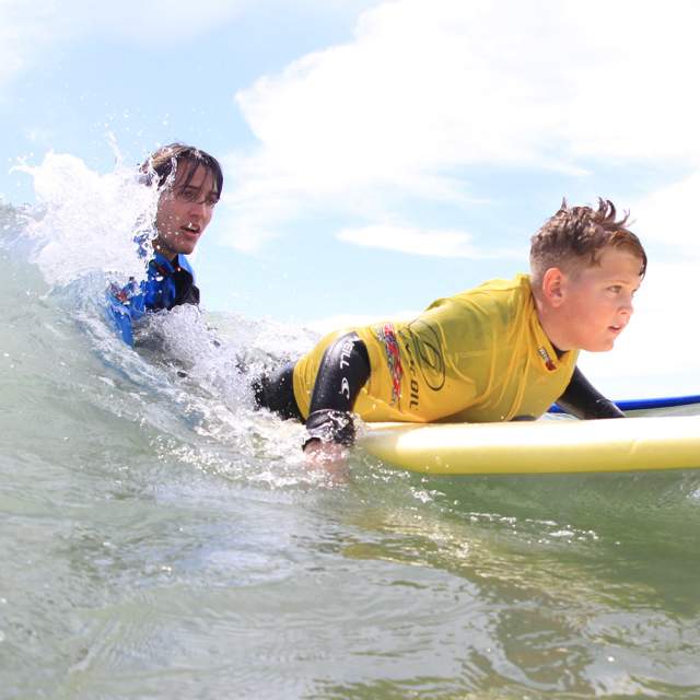 Boy learning to surf with 2XS