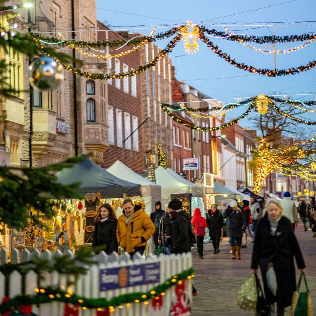 A view of Chichester city centre with Christmas lights and decorations and market stalls