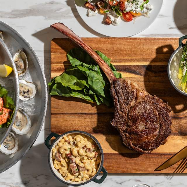 Overhead shot of meat and vegetables on a cutting board at Le Moyne's Chophouse in Mobile, AL things to eat