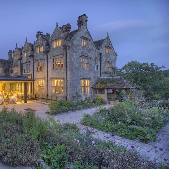 External view of Graveytye Manor and restaurant from the gardens, taken in the evening