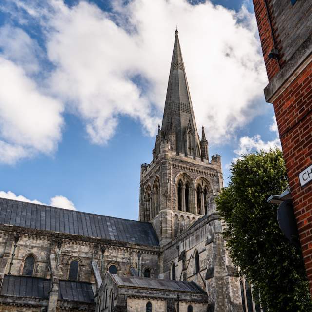 Exterior view of Chichester Cathedral from Chapel Street looking at the spire