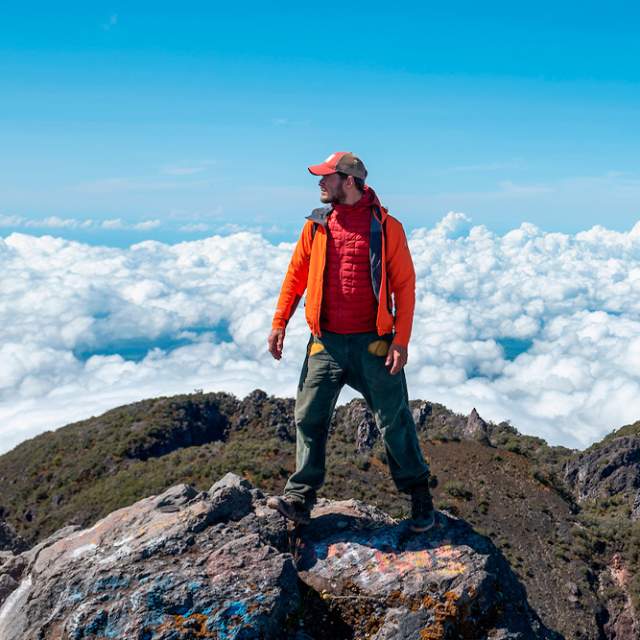 Man standing on a mountain summit above the clouds in Tierras Altas, Chiriqui