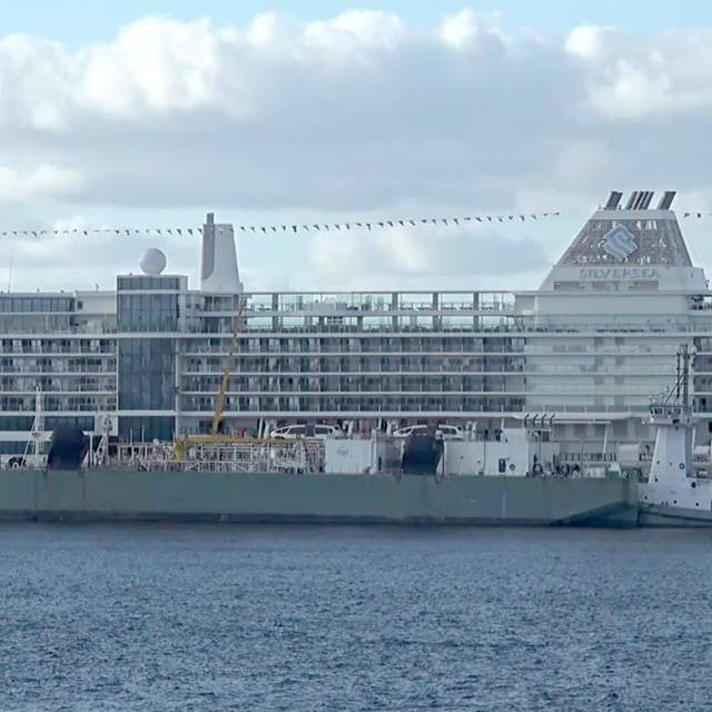 LNG Bunkering barge fuels a cruise ship.