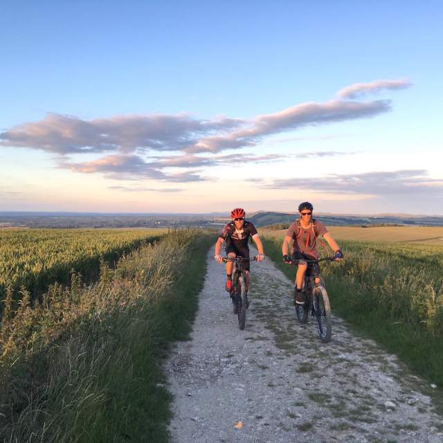 Two people cycling in countryside