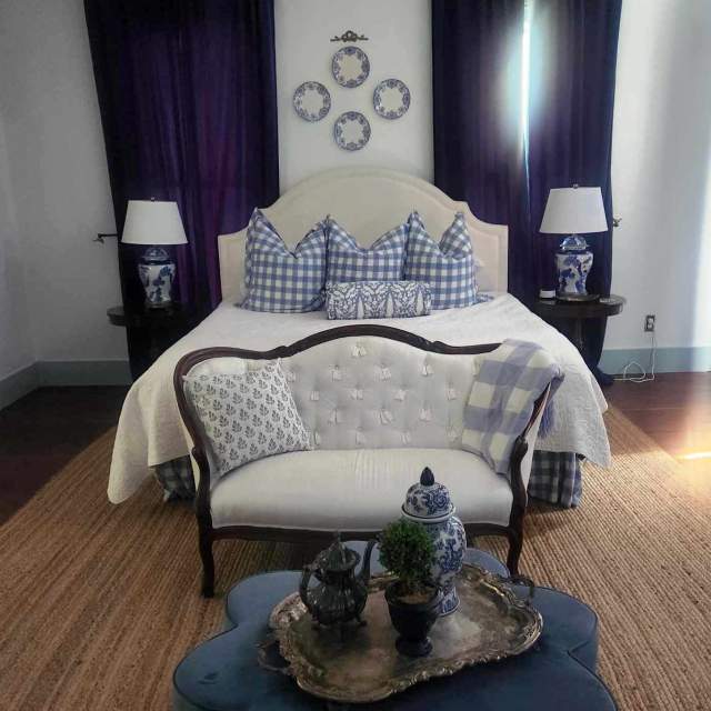 Blue and white bedroom with wood floors at The Bingham Estate