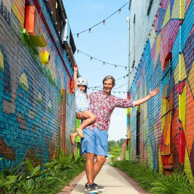 Dad and daughter skateboarding by "Alley on State" mural in West Columbia (Vagabond3 visit).