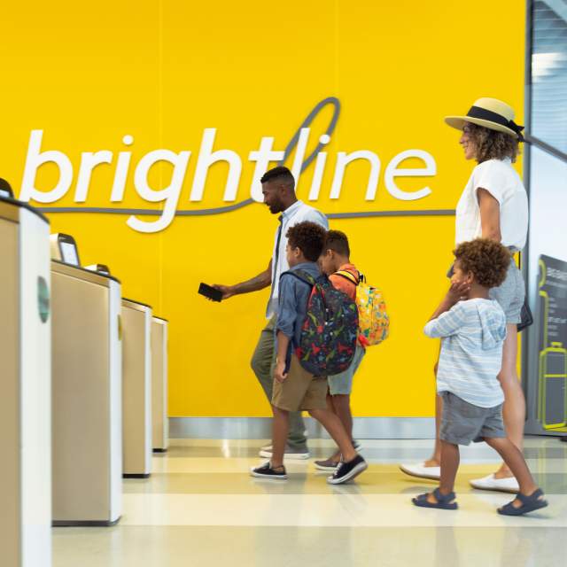 Family scanning tickets at Brightline station