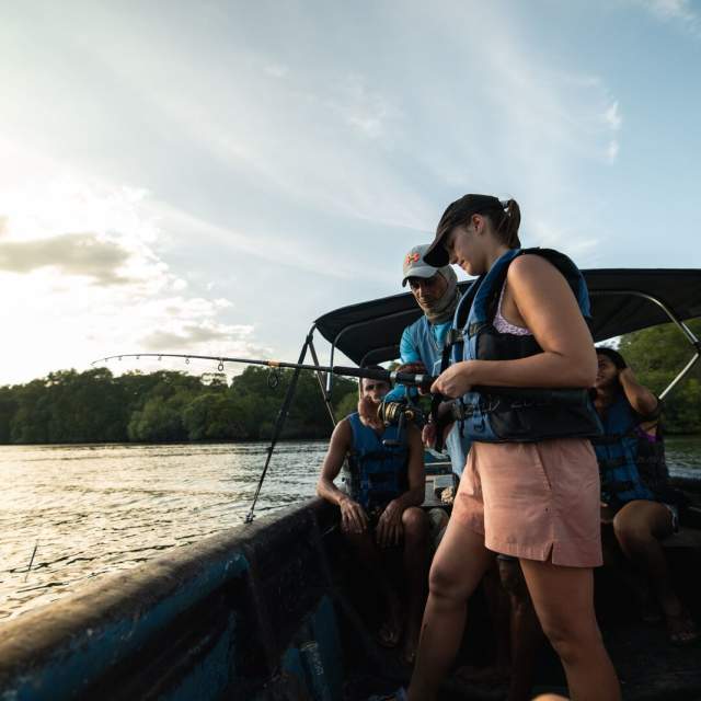 Group of tourists on a boat learning how to fish along the Pacific Coast of Panamá.