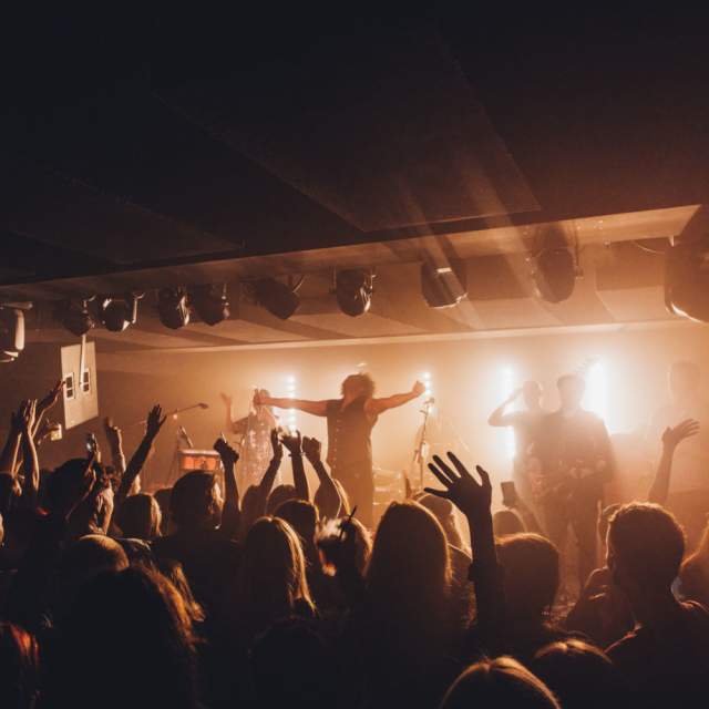 Band performing on stage in front of a crowd
