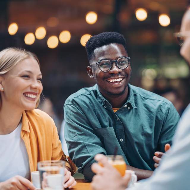 Multi-ethnic group of friends in a restaurant - Orlando Health Magical Dining