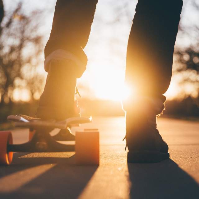 a picture of a person's legs and a skateboard