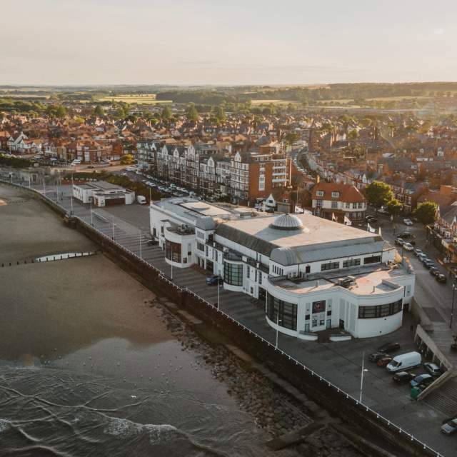 An exterior drone shot of Bridlington south beach, The Spa and town.