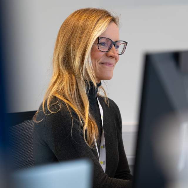 An image of a receptionist looking at their computer screen.