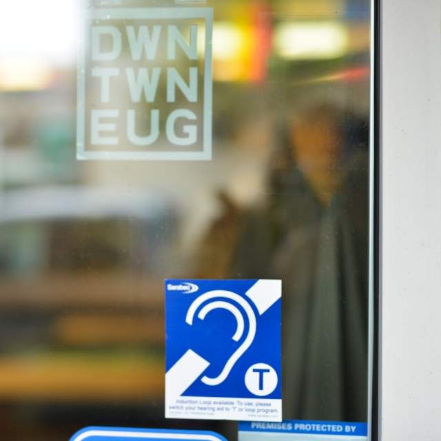 A hearing loop logo is on the glass window of the downtown visitor center indicating that the center is looped.
