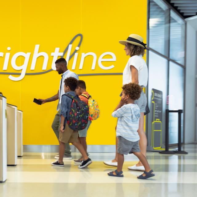Family scanning tickets at Brightline station