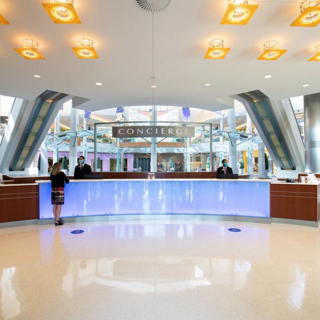 The Mall at Millenia concierge desk with employees wearing face masks.