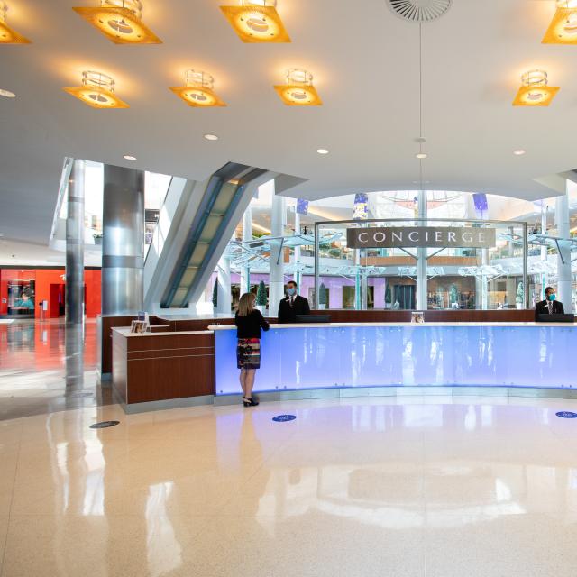 The Mall at Millenia concierge desk with employees wearing face masks.