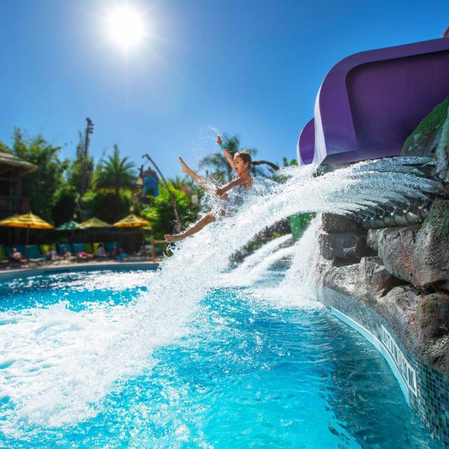 A little girl coming out of a water slide in Universal's Volcano Bay.