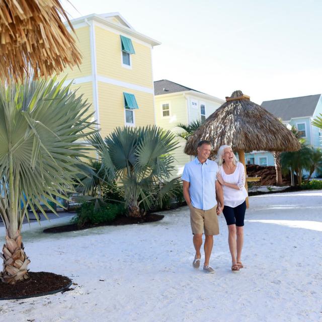 A couple walking along cottages at Margaritaville Resort Orlando.