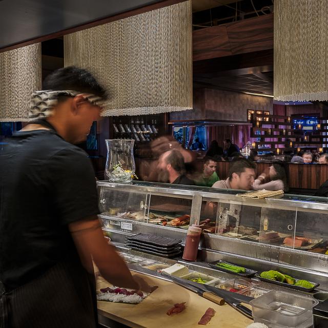 View from behind sushi chefs at Dragonfly - Robata Grill & Sushi on Restaurant Row