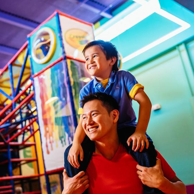 A father and son near the playground at Crayola Experience in Orlando