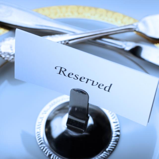 Reserved seating placard on a table at a formal dinner.