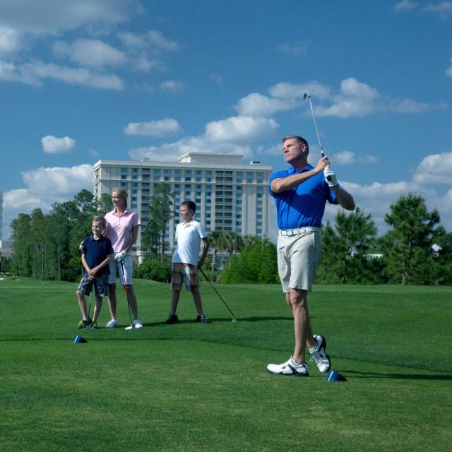 A family playing golf at the Waldorf Astoria Golf Club