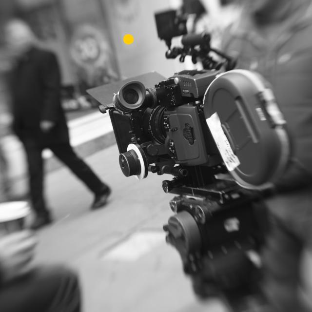 A black and white photograph of a movie camera.