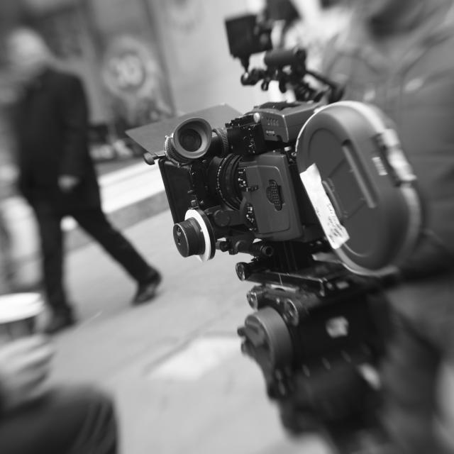 A black and white photograph of a movie camera.
