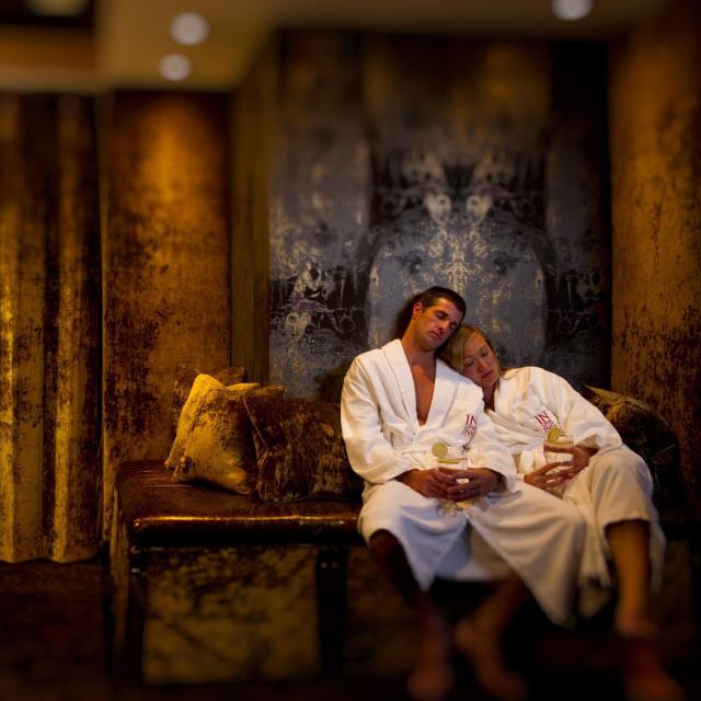 A couple relaxing inside the Poseidon Spa at Grand Bohemian Hotel Orlando.