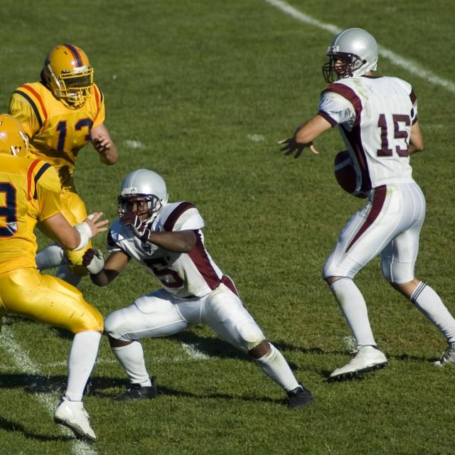 quarterback with the football during a game