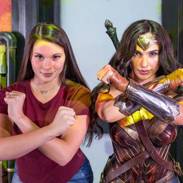 Woman poses with Wonder Woman at Madame Tussauds