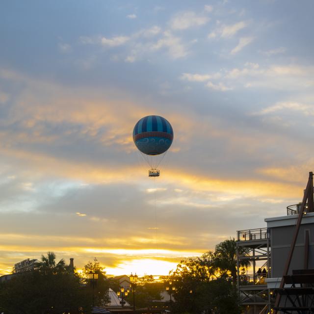 A hot-air balloon floating high above the water at Disney Springs