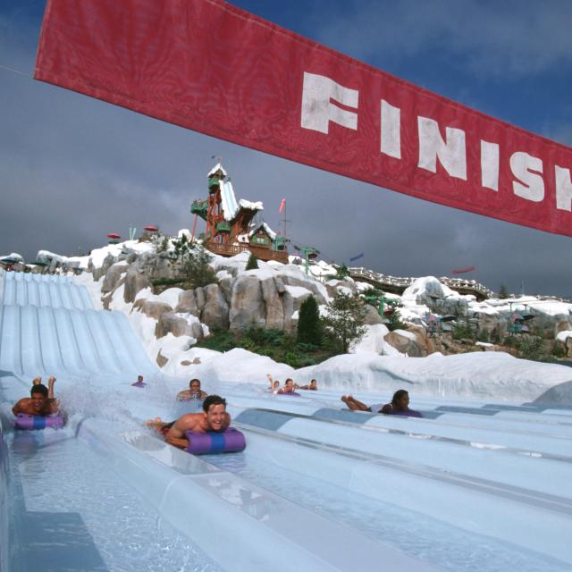 Tobaggan racers slide down to the finish at Disney's Blizzard Beach Water Park