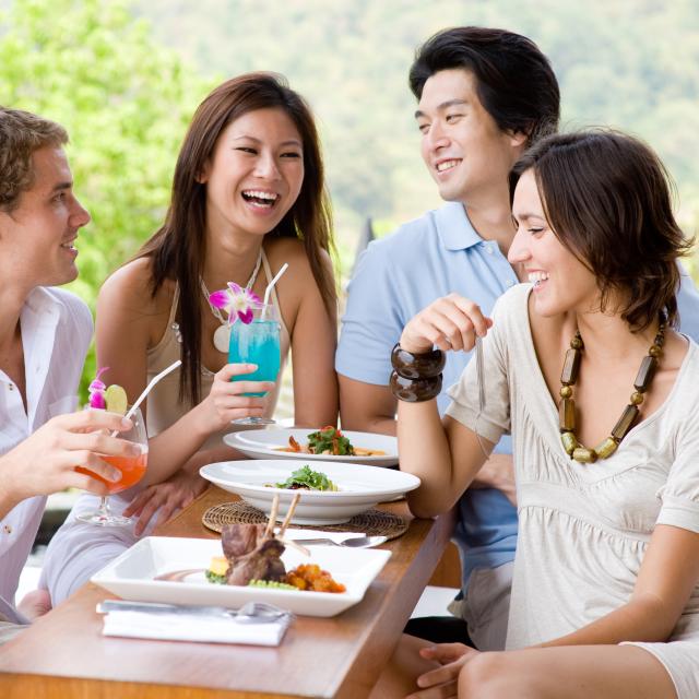 Two young couples having dinner and drinks
