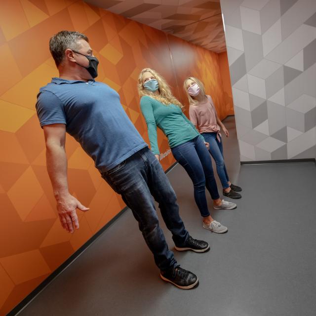 Museum of Illusions tilted room family masks