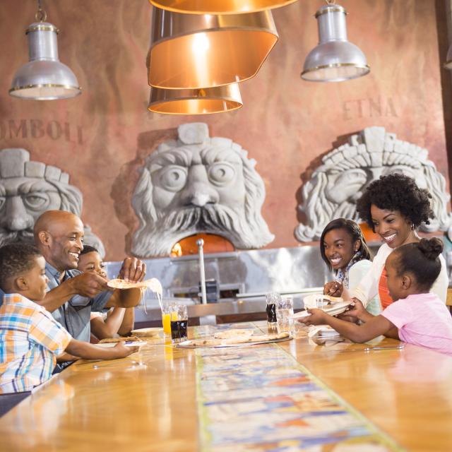 A family dining at Via Napoli Ristorante e Pizzeria at Epcot®