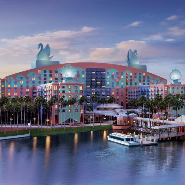 Lakeside view of Swan and Dolphin Resort at Walt Disney World Resort, during sunset.