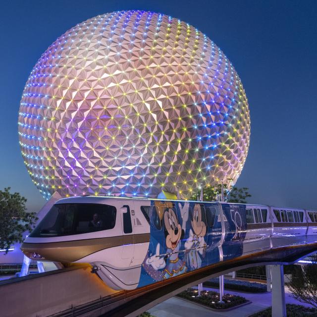 Night shot of monorail in front of Spaceship Earth at Epcot®